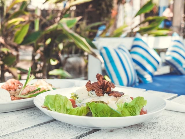 A chicken caesar salad on a white table